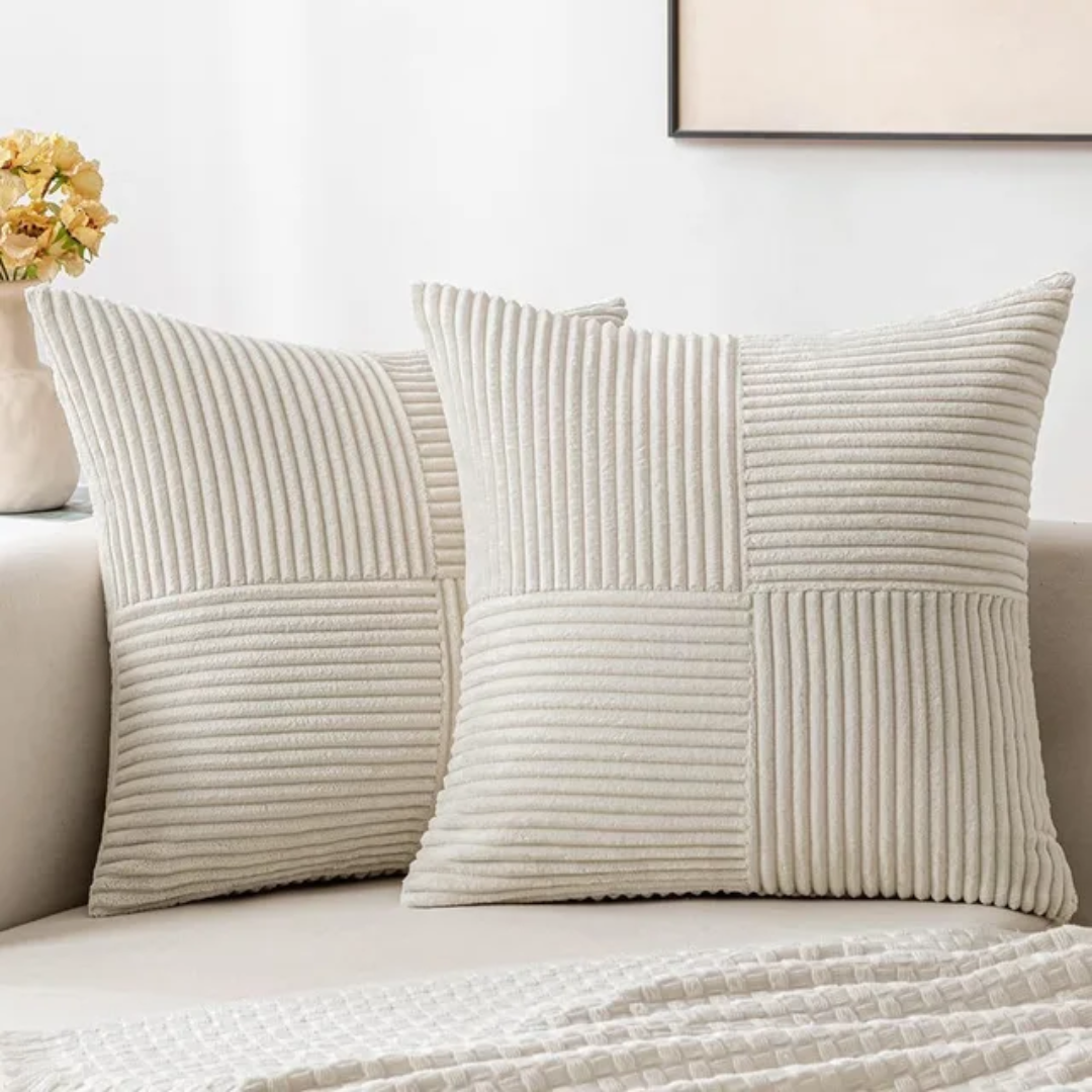 Cushion cover in blue styled on a bed