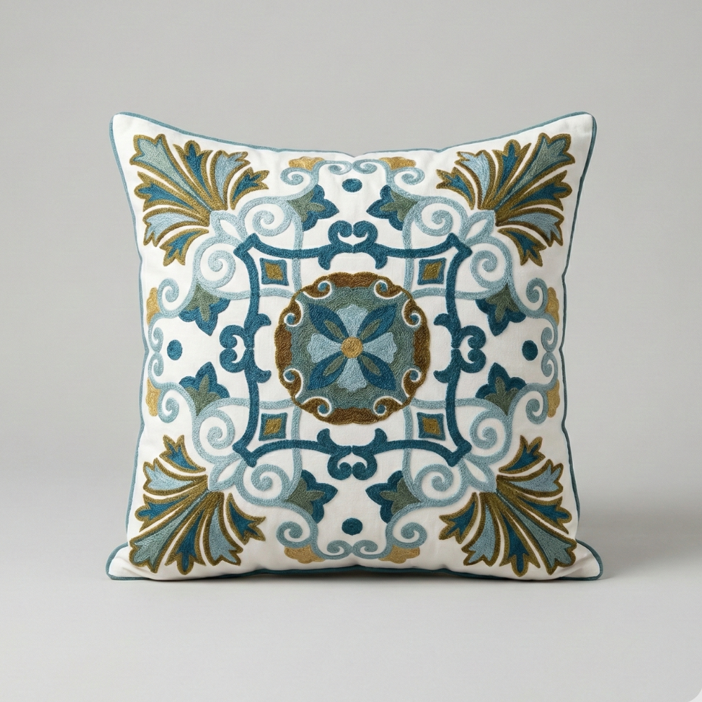 Embroidered cushion in terracotta